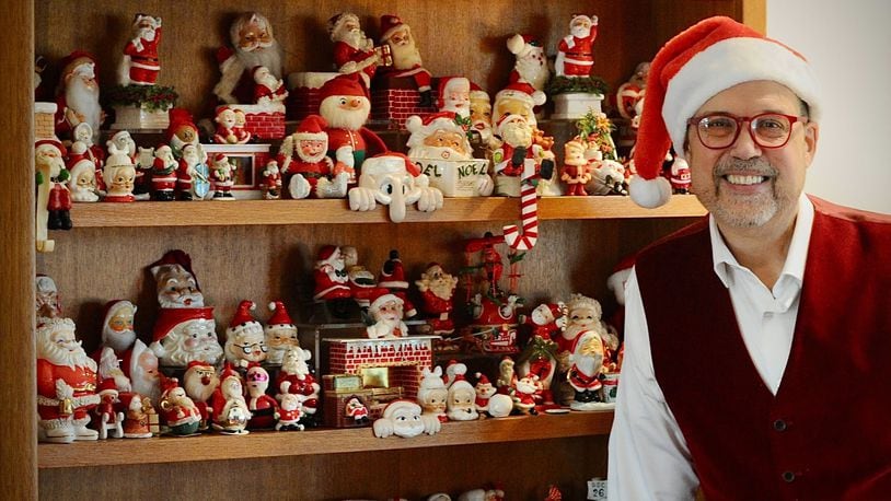 Michael Roediger, director of the Dayton Art Institute, collects Santa figures and has a collection of 500 of them. MARSHALL GORBY\STAFF