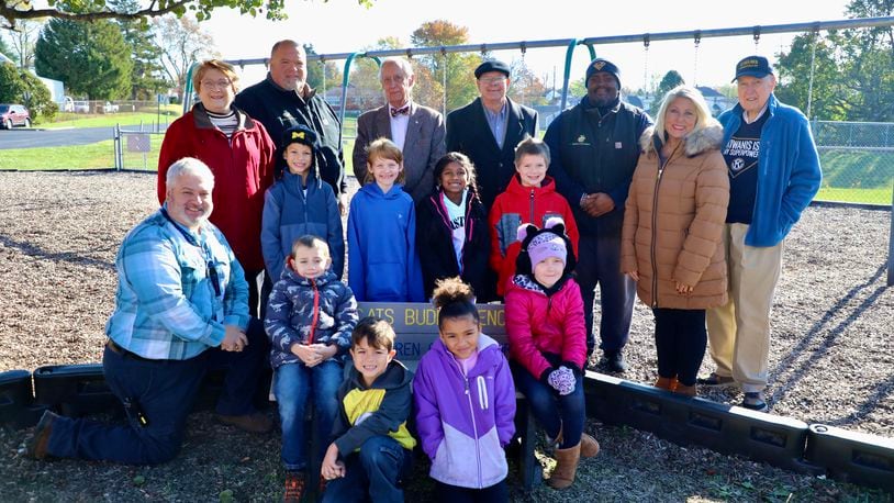 The Springfield City School District received 10 buddy benches that were donated from the Kiwanis Club of Springfield. They were placed on the playgrounds at each of the elementary schools, including Kenwood. In this photo (back row, from left to right) is Kenwood Elementary Principal Mike Wallace, Kiwanis Club President Susan Hillman, David Cook (Plastic Lumber Store), Kiwanis Representative Denis Driscoll, Kiwanis Representative Carl Patterson, Justin Johnson (Plastic Lumber Store). Springfield Local School District's Director of Communications Cherie Moore and Kiwanis Representative Dick Rice. Contributed