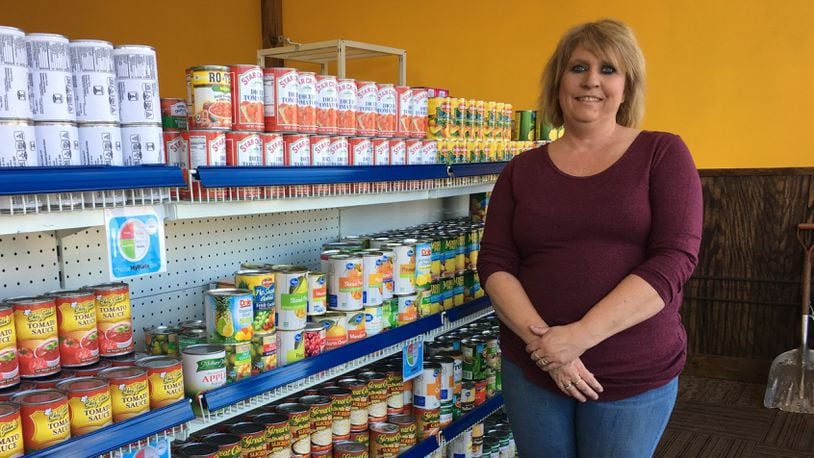 Nicole Adkins, With God's Grace executive director, stands inside the non-profit's new free grocery store at 5505 North Dixie Dr. in Dayton.