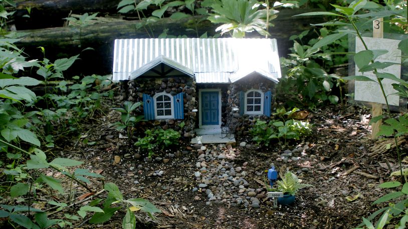 Aullwood Audubon Center Faerie House Exhibit is on display through Labor Day. The miniature homes are created from natural materials. Judi Hill, one of five volunteers to work on this year's project, features pebbles in this home's design.  DAVE HILL/COURTSEY PHOTO