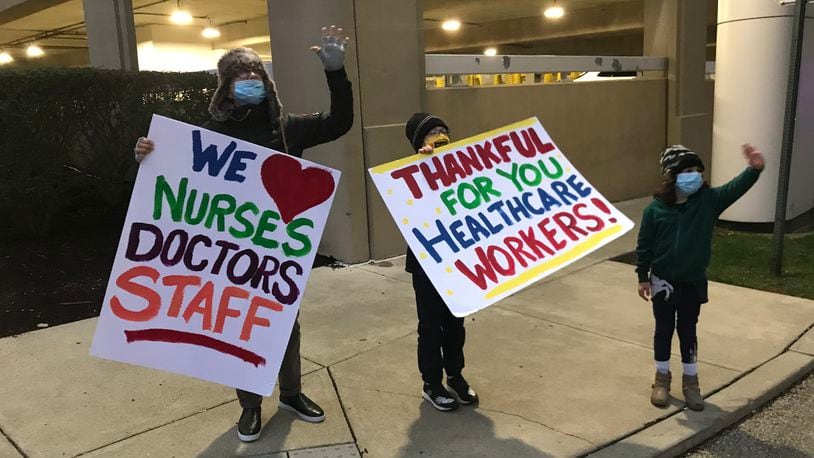 Julia Reichert and grandchildren Beau and Dory thank healthcare workers outside of Miami Valley Hospital on Thanksgiving Day.