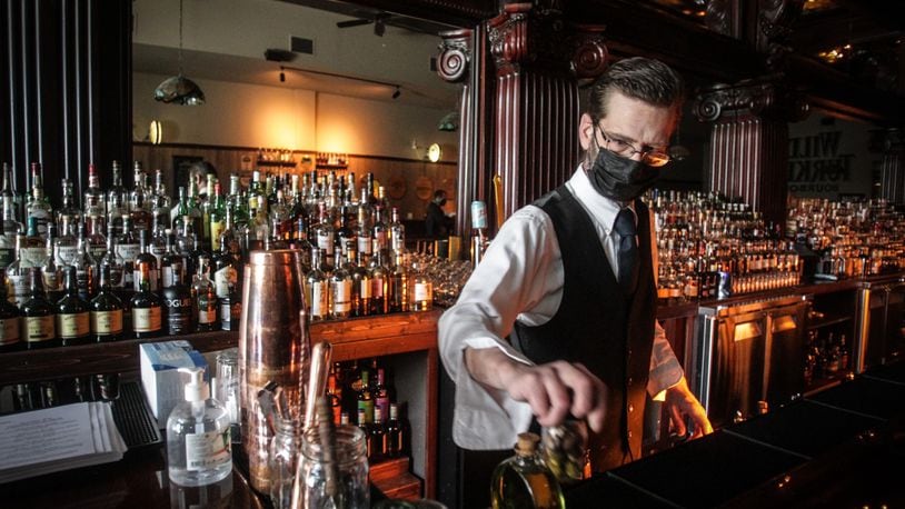 Century Bar barkeep, Mark Pittman, readying the bar for the first Friday night without a curfew. Jim Noelker/Staff