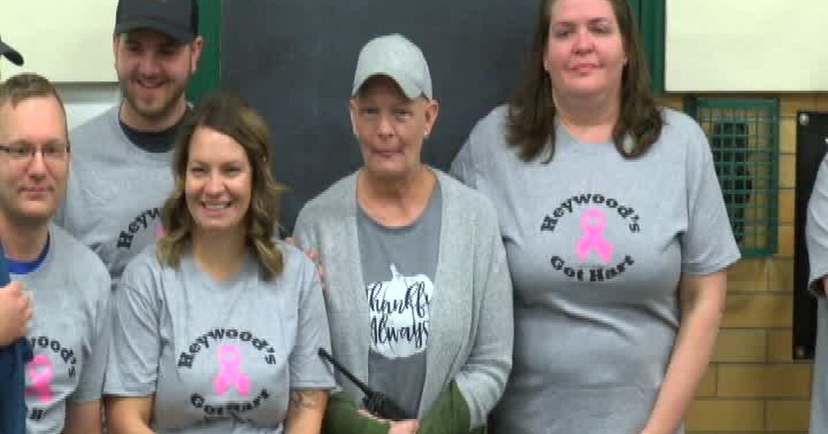 Troy school students surprise staff member who is battling cancer