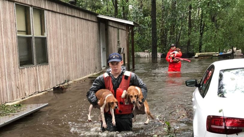 United States Coast Guard members of Shallow-Water Response Team 3 rescued beagles and their owners stranded by floodwater from Hurricane Florence. (Photo by USCG 5th District Mid Atlantic)
