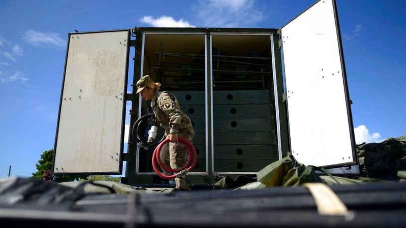 A member of the US army reserve works to set up up portable showers in a tent city for hundreds of people displaced by earthquakes in Guanica, Puerto Rico, Tuesday, Jan. 14, 2020. A 6.4 magnitude quake that toppled or damaged hundreds of homes in southwestern Puerto Rico is raising concerns about where displaced families will live, while the island still struggles to rebuild from Hurricane Maria two years ago. (Carlos Giusti/AP)